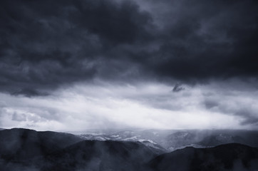 dramatic storm clouds in dark landscape