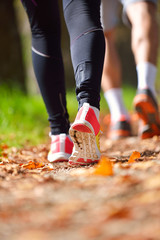 Young couple jogging in park at morning. Health and fitness.