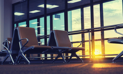 passenger seat in Departure lounge for see Airplane, view from airport terminal.sun light in vintage color selective focus