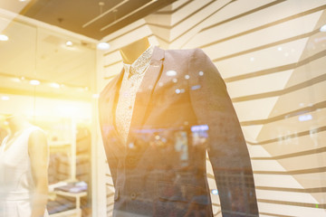 classic vest against row of suits in shop , Men elegant clothing showcase Look through the glass,vintage color