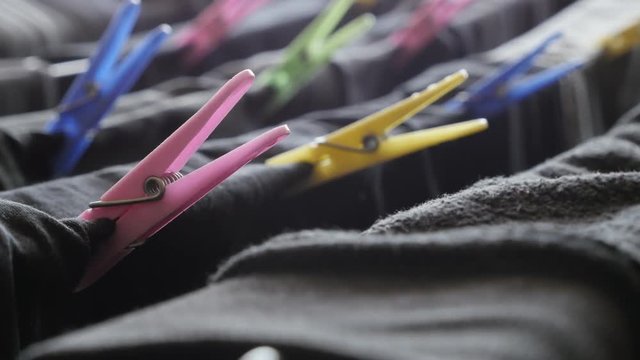 Tilting over different spring pegs on drying rack 4K 2160p 30fps UltraHD footage - Colorful clothespins on airer slow tilt 3840X2160 UHD video