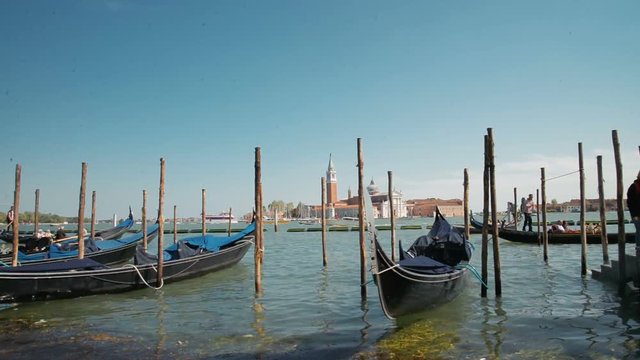 April 2017 - Gondolas and view to Chiesa di San Giorgio Maggiore Church of San Giorgio Maggiore and Fondazione Giorgio Cini right before the sunset in Venice, Italy