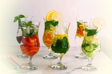 Healthy summer refreshing drinks made from fresh fruits in assortment on a white background