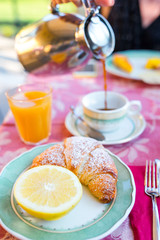 Tasty traditional appetizing yummy breakfast at the restaraunt outdoors. Fresh coffee and croissant