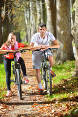 Fototapeta na wymiar Couple On Cycle Ride In Countryside