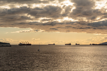 Obraz na płótnie Canvas Photo of boats on cloudy sunset at English Bay, Vancouver, BC