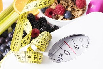 tape measure with scale, fruit and cereal, diet concept