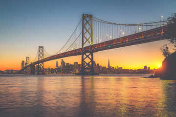 San Francisco skyline with Oakland Bay Bridge at sunset, California, USA