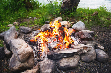 A hot fire with red burning coals in a stone edging