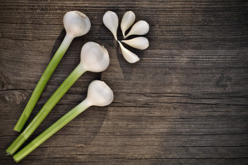 Fresh garlic and garlic bulblet on wooden background