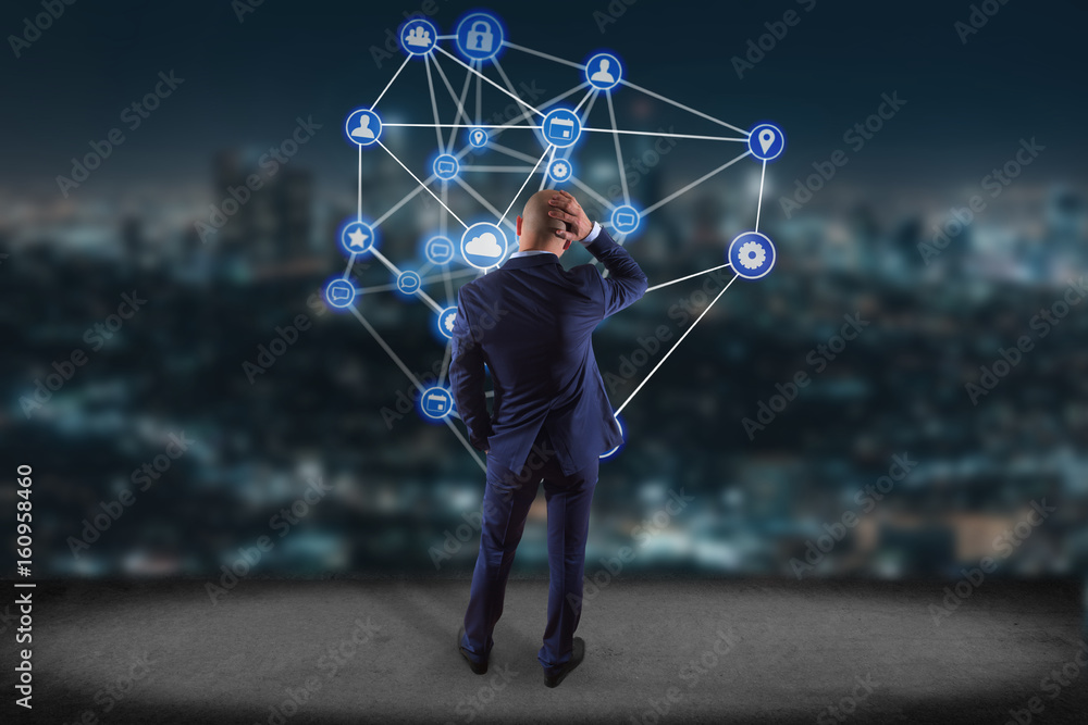 Poster businessman in front of a wall with a business network connection displayed on a futuristic interfac