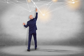 Businessman in front of a wall with Web operating system screen and network connection displayed on...