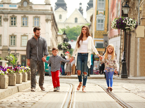 Young Family With Two Kids Walking Street Old Tourist City