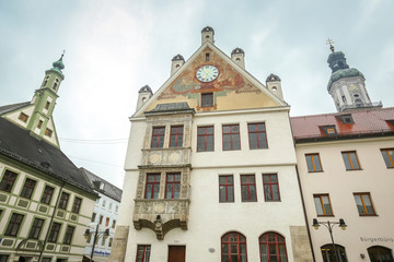 A low angle view of the town hall with clock and Saint Georges Church belfry at town square in...