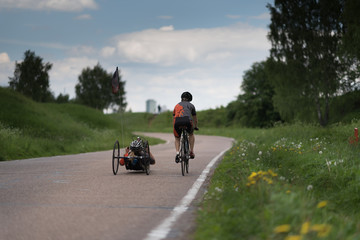 Naklejka premium Man ride bycicle and his friend ride recumbent
