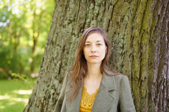 Portrait of young woman by tree