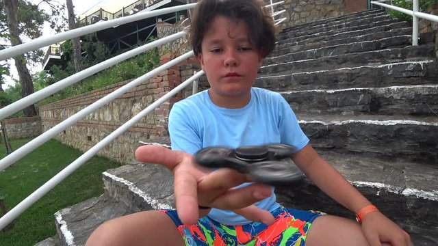 Teenager spinning a fidget spinner
