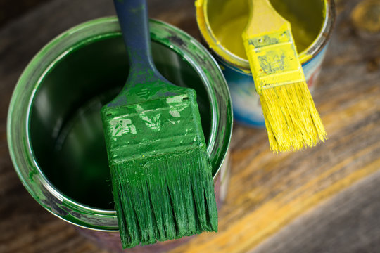 Colourful Paint Cans And Paintbrushes On The Floor Viewed From Above