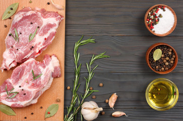 fresh raw meat with spices on wooden table. top view with copy space