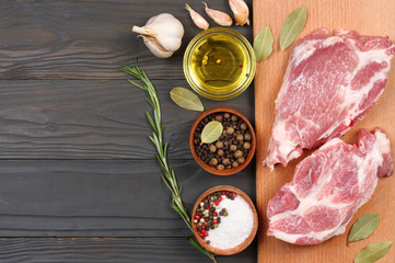 fresh raw meat with spices on wooden table. top view with copy space