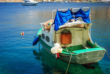 The blue sea, the coast and the beautiful sunny day. Fishing boat, with all the equipment necessary...