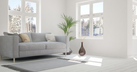 White room with sofa and winter landscape in window. Scandinavian interior design. 3D illustration