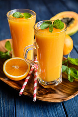Healthy papaya, orange and mango smoothie