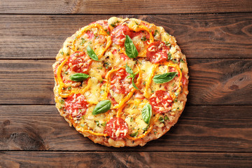 Tasty Italian pizza on wooden table