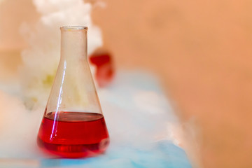 Chemical experiment. Thick white smoke from the flask.