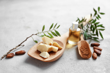 Beautiful composition with cocoa butter lotion on table