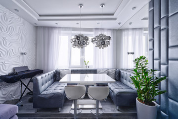 Modern design interior of living room in a luxury apartment in gray and white tones.