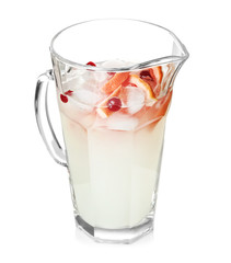 Tasty refreshing lemonade with grapefruit and cranberry in glass jug on white background