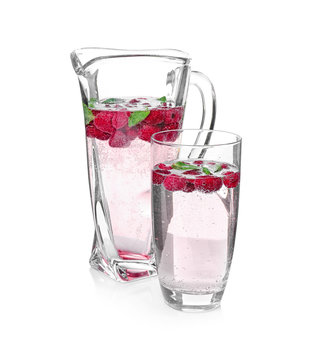 Tasty refreshing lemonade with berries on white background