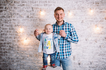 Fototapeta na wymiar Picture of laughing dad and son dressed in plaid shirts