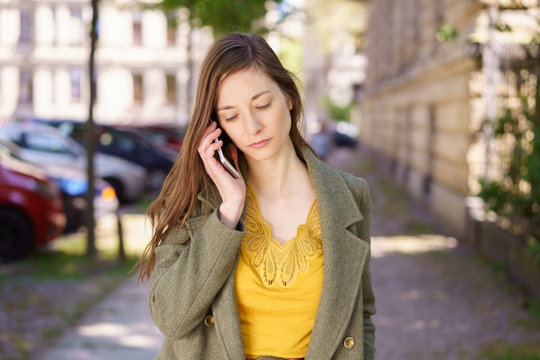 Sad depressed young woman listening to a call