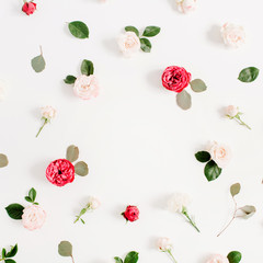 Round frame wreath pattern with red and beige rose flower buds, branches and leaves isolated on white background. Flat lay, top view. Floral background