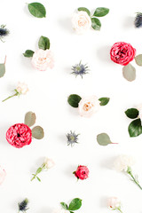 Flower pattern made of red and beige roses, green leaves, branches on white background. Flat lay, top view. Valentine's background. Pattern of flowers. Floral texture.