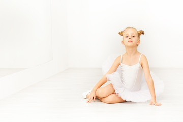 Portrait of little ballet dancer in white tutu