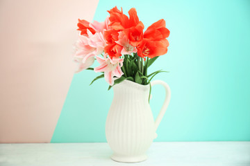 Vase with beautiful tulips on color background