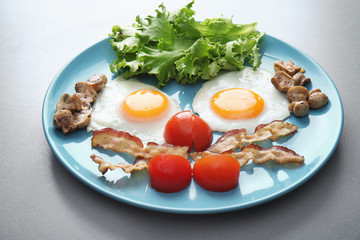 Tasty breakfast with eggs on plate