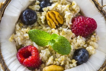 Russian porridge with juicy berries and nuts flatlay