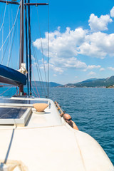 Fototapeta na wymiar A picturesque landscape is visible from the side of the sailing yacht.