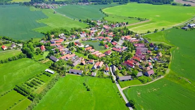 Aerial view of beautiful village in summer countryside. Circular shape traditional village Lipnice in Brdy, Czech republic, Europe. Drone camera flying over beautiful landscape.