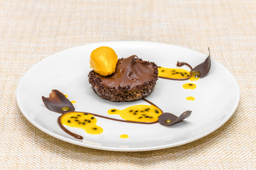 Chocolate tartlet with mango mousse and mango sorbet