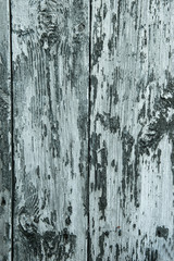 abstract wooden background with cracks on the blue paint, vertical frame.