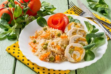 Stuffed chicken roll with spicy rice and vegetables
