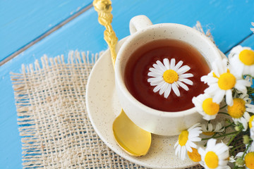 cup of herbal chamomile tea with camomile dry blossoms, dried camomile flowers. doctor treatment...