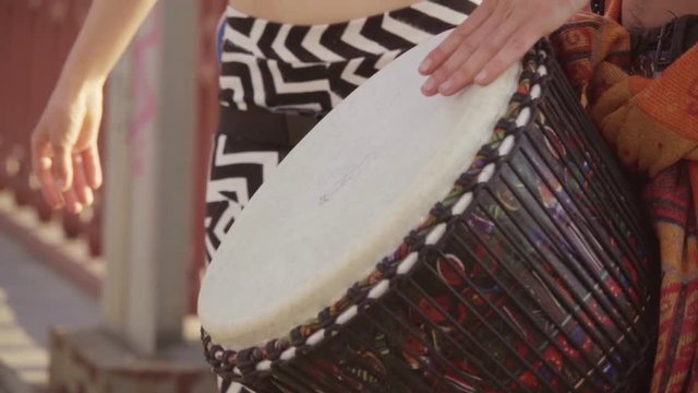 Djembe drumming in slow motion. Close up hands