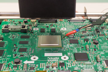 TV repair. Soldering an electronic chip on an infrared rework soldering station