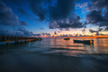 Sunrise over the Caribbean sea and speed boats